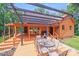 Inviting outdoor deck area with pergola, seating, and access to home's interior at 6350 Mount Pleasant S Rd, Concord, NC 28025