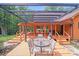 Inviting outdoor deck area with pergola, seating, and access to home's interior at 6350 Mount Pleasant S Rd, Concord, NC 28025