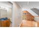Bright hallway leading to a bathroom with a wooden vanity and a view of the living area at 6350 Mount Pleasant S Rd, Concord, NC 28025
