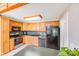 A functional kitchen features wooden cabinets and black appliances at 6350 Mount Pleasant S Rd, Concord, NC 28025