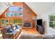 Spacious living room with brick fireplace, hardwood floors, and large windows at 6350 Mount Pleasant S Rd, Concord, NC 28025