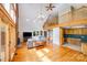 Open living room features hardwood floors, a brick fireplace, and a vaulted ceiling with loft access at 6350 Mount Pleasant S Rd, Concord, NC 28025