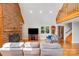Spacious living area features a brick fireplace, hardwood floors, and vaulted ceiling at 6350 Mount Pleasant S Rd, Concord, NC 28025