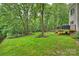 Lush backyard with mature trees and a deck perfect for outdoor entertaining and enjoying nature at 6722 Elmstone Dr, Charlotte, NC 28277