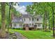 Home exterior showcasing the deck, backyard with manicured landscaping, and mature trees at 6722 Elmstone Dr, Charlotte, NC 28277