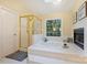 Bathroom featuring soaking tub, glass enclosed shower and fireplace at 6722 Elmstone Dr, Charlotte, NC 28277