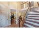 Spacious foyer featuring hardwood floors, an elegant staircase, and views of the living spaces at 6722 Elmstone Dr, Charlotte, NC 28277