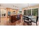 Eat-in kitchen featuring a center island, stainless steel appliances, and an adjacent eat-in nook at 6722 Elmstone Dr, Charlotte, NC 28277