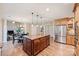 Spacious kitchen with granite countertops, wooden cabinetry, and stainless steel refrigerator at 6722 Elmstone Dr, Charlotte, NC 28277