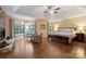 Luxurious main bedroom with a fireplace, tray ceiling, and large windows at 6722 Elmstone Dr, Charlotte, NC 28277