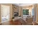 Sitting area with stone fireplace, next to the door to the bath and closets at 6722 Elmstone Dr, Charlotte, NC 28277