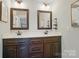 Well-lit bathroom boasts a double vanity with framed mirrors and modern fixtures at 7006 Nesbit Rd, Waxhaw, NC 28173