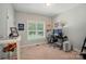This bedroom features carpet, a window, a desk with computer, and display shelves for a personalized space at 7006 Nesbit Rd, Waxhaw, NC 28173