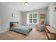 Cozy bedroom with a twin bed, soft armchair, and large window providing ample natural light at 7006 Nesbit Rd, Waxhaw, NC 28173