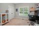 A bedroom includes carpet, a window, a computer desk setup, and a display cabinet, ideal for gaming or hobbies at 7006 Nesbit Rd, Waxhaw, NC 28173