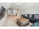 An upstairs bonus room is furnished with a sofa, desk, and TV, making it ideal for recreation and study at 7006 Nesbit Rd, Waxhaw, NC 28173
