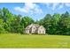 Stunning brick home with manicured lawn and mature trees, exuding curb appeal at 7006 Nesbit Rd, Waxhaw, NC 28173