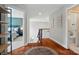 A hardwood hallway leads to rooms, with wooden stairs and a decorative rug adding warmth and character at 7006 Nesbit Rd, Waxhaw, NC 28173