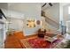 Open living area with hardwood floors, staircase, and view into the kitchen at 7006 Nesbit Rd, Waxhaw, NC 28173