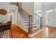 Elegant staircase with iron railings and hardwood steps at 7006 Nesbit Rd, Waxhaw, NC 28173