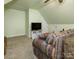 Finished attic featuring a comfortable seating area and entertainment setup, perfect for relaxation at 725 Old State Sw St, Concord, NC 28027