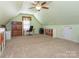 Well-lit attic space with neutral carpeting, ideal for a home office or hobby area, with storage options at 725 Old State Sw St, Concord, NC 28027