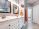 This bathroom features dual sinks, with vanity, tiled floor, and an adjacent shower at 725 Old State Sw St, Concord, NC 28027