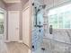 A bathroom featuring a tiled shower with glass enclosure, bench, and tile flooring at 725 Old State Sw St, Concord, NC 28027