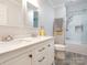 Bright bathroom featuring a double vanity, modern fixtures, and a tiled shower with glass door at 725 Old State Sw St, Concord, NC 28027