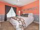 Cozy bedroom with a large window, plush carpet, and a comfortable bed with decorative pillows at 725 Old State Sw St, Concord, NC 28027