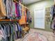 A walk-in closet with custom shelving and storage, a window and a unique rug at 725 Old State Sw St, Concord, NC 28027