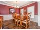 Formal dining room with hardwood floors, a chandelier, and a large window at 725 Old State Sw St, Concord, NC 28027