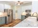 Updated kitchen with stainless steel appliances, white cabinets, granite countertops, and hardwood floors at 725 Old State Sw St, Concord, NC 28027
