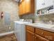 Bright laundry room with washer, dryer, sink, and custom cabinets for ample storage at 725 Old State Sw St, Concord, NC 28027