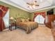 This main bedroom offers carpeted floors, a ceiling fan, a TV, a dresser, and natural light at 725 Old State Sw St, Concord, NC 28027