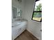 Chic bathroom with white vanity, modern fixtures, and a sleek design, complemented by a large window at 760 3Rd Street Sw Pl, Hickory, NC 28602