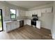 Modern kitchen features white cabinets, stainless steel appliances, and stylish countertops with views of the backyard at 760 3Rd Street Sw Pl, Hickory, NC 28602