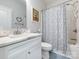 Bright bathroom with a single vanity, floral shower curtain, and white fixtures at 805 Brookmont Ave, Salisbury, NC 28146