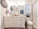 Bright bathroom with double vanity, updated fixtures, and a decorative wall clock at 805 Brookmont Ave, Salisbury, NC 28146