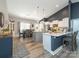 Open-concept kitchen featuring white cabinetry, an island with counter seating, and stainless appliances at 805 Brookmont Ave, Salisbury, NC 28146