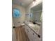 Bright bathroom featuring granite countertop, white cabinetry, and modern fixtures at 807 S Bostian St, China Grove, NC 28023
