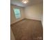 Cozy bedroom features neutral carpet and a window at 807 S Bostian St, China Grove, NC 28023