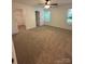Cozy bedroom featuring neutral carpet, two windows, and a large walk-in closet at 807 S Bostian St, China Grove, NC 28023