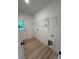 Efficient laundry room featuring modern flooring, shelving, and utility connections at 807 S Bostian St, China Grove, NC 28023