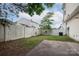 Back yard featuring a concrete patio and a white wooden fence surrounding the perimeter at 8432 Spirea Ct, Charlotte, NC 28215
