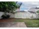 View of a fenced back yard with a small concrete patio and minimal grass at 8432 Spirea Ct, Charlotte, NC 28215