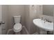 Clean half bath with pedestal sink, tile flooring, and neutral wall color at 8432 Spirea Ct, Charlotte, NC 28215