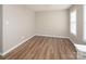 Bedroom featuring wood floors, one window, and a neutral paint scheme at 8432 Spirea Ct, Charlotte, NC 28215