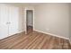 A bedroom features a closet, wood flooring, and neutral paint for a calm and inviting space at 8432 Spirea Ct, Charlotte, NC 28215