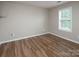 Neutral bedroom with wood-look floors and a bright window for natural light at 8432 Spirea Ct, Charlotte, NC 28215